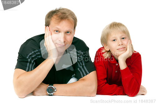 Image of Dad and son lying on the floor in the studio