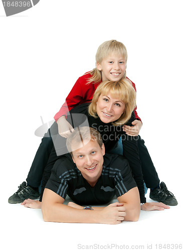 Image of happy family lying on the floor