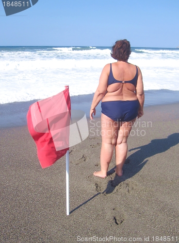 Image of Overweight woman on a beach