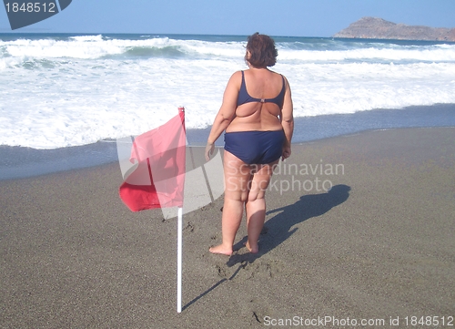 Image of Obese woman on a beach