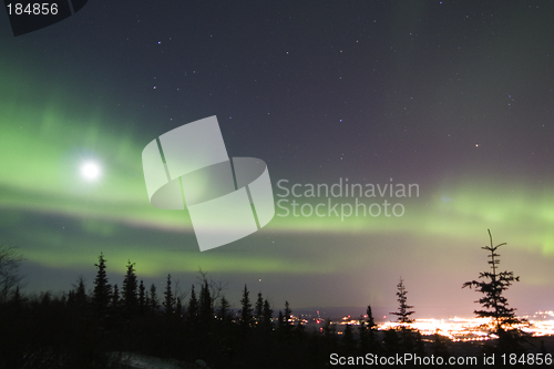 Image of Full Moon and active colorful aurora over Fairbanks Alaska