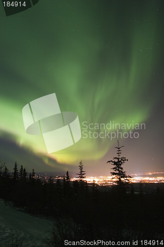 Image of Active Aurora Borealis in the sky over town lights