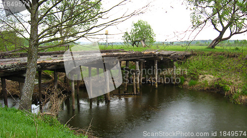 Image of Old almost destroyed bridge across river