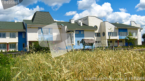 Image of School on a background of a field with wheat