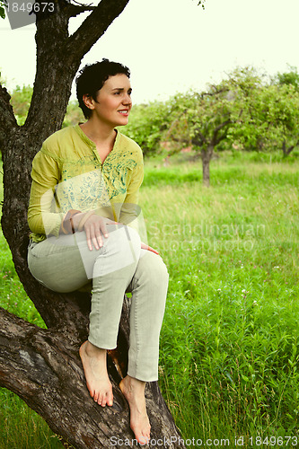 Image of girl sitting on a tree