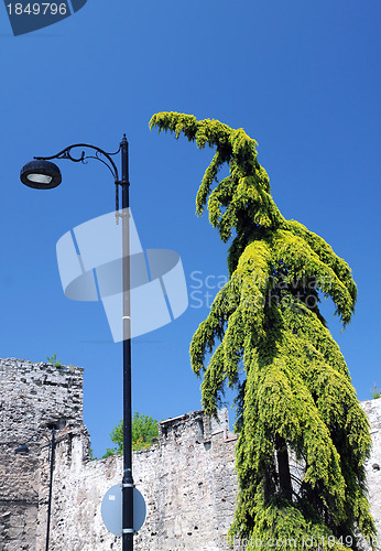 Image of Green Figure and Lamp Pole