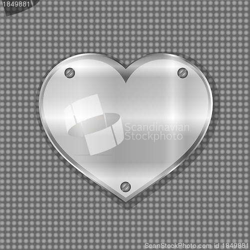 Image of metal heart label on steel background