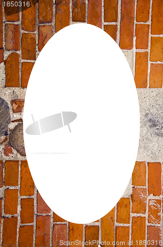 Image of red brick stones wall and white oval in center 