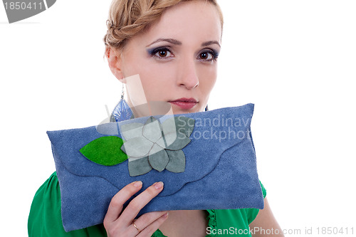 Image of woman with purse looking at the camera