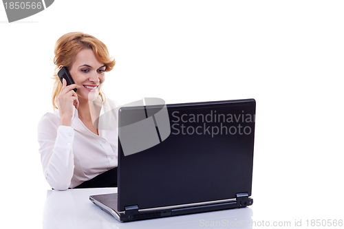 Image of business woman using cell phone at desk 