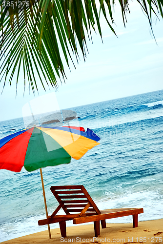 Image of umbrella and lounge chair on the exotic island