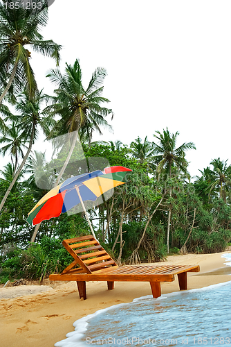 Image of umbrella and lounge chair on the exotic island