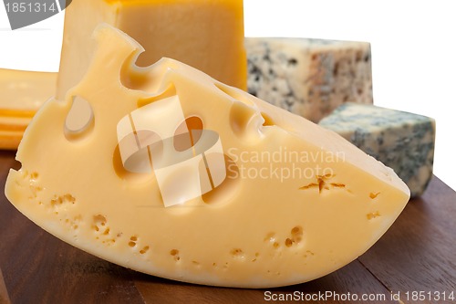 Image of Different types of cheese on wooden table