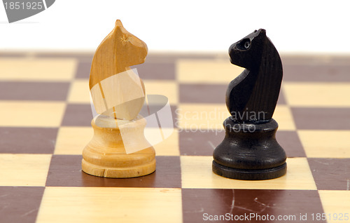 Image of Gold crocodile nut crush tool on chess board 