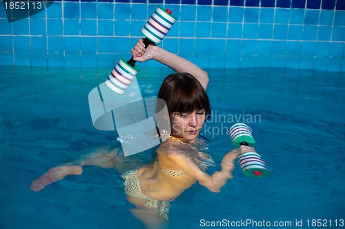 Image of Attractive girl trains in aqua aerobics