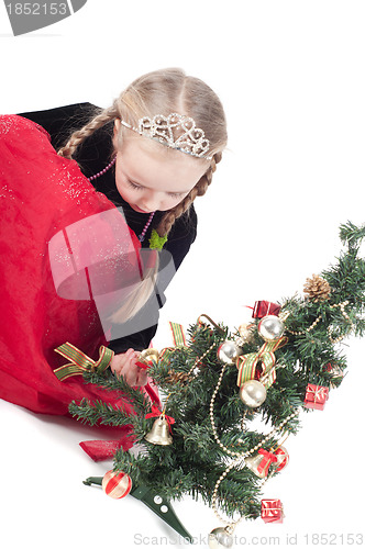 Image of Cute girl with small christmas tree