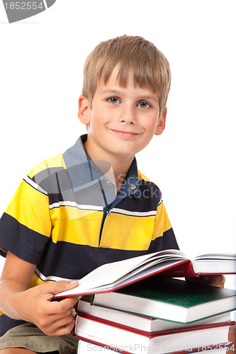 Image of Schoolboy is sitting on books
