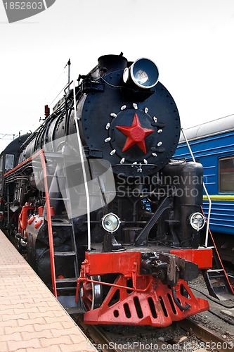 Image of Old steam train is leaving a station
