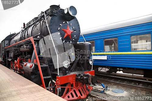 Image of Old steam train is leaving a station