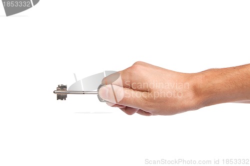 Image of Male hand holding a key to the house