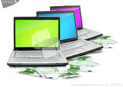 Image of Open laptop with money 