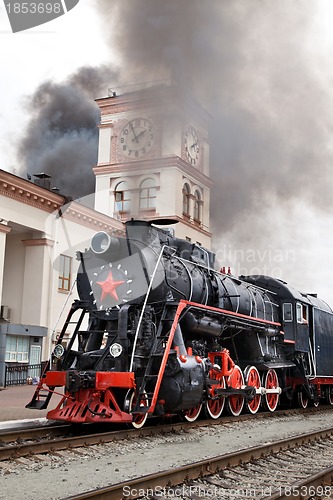 Image of Old steam train is leaving a station