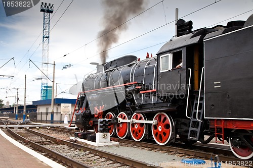 Image of Old steam train is leaving a station