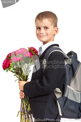 Image of Schoolboy is holding flowers. Back to school