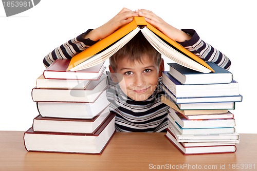 Image of Schoolboy and a heap of books isolated on a white background