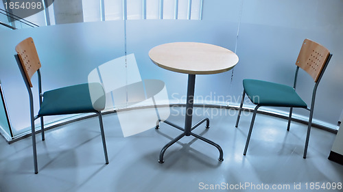 Image of two chairs and round table