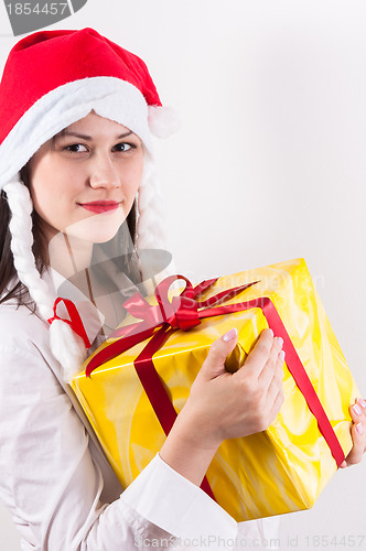 Image of Young woman with christmas present