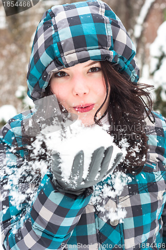 Image of Woman blowing snow in my face