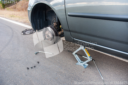 Image of Car without tire on the road