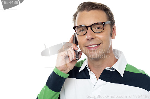 Image of Young man communicating via cellphone