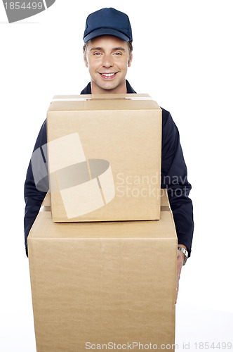 Image of Young man carrying huge cardboard boxes