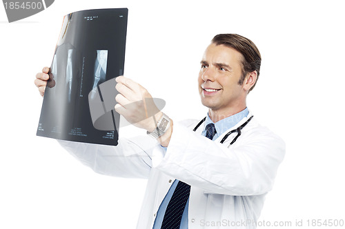 Image of Experienced orthopedic surgeon reviewing x-ray report