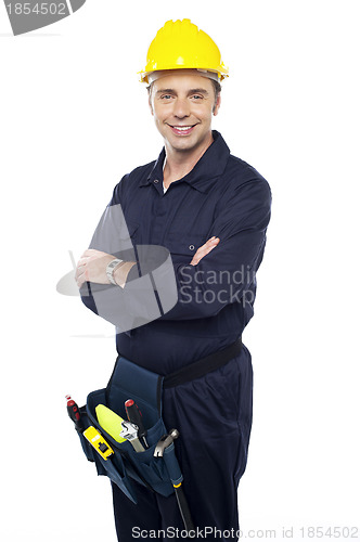 Image of Smiling young craftsman with tool pouch around his waist