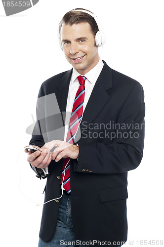 Image of Relaxed business executive tuned into music