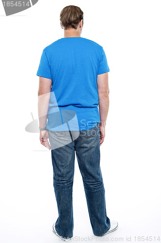 Image of Rear view of casual young guy posing