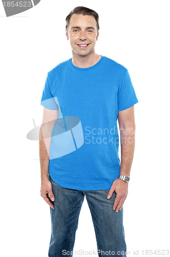 Image of Cheerful calm male model posing in trendy casuals