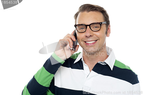 Image of Joyous young man communicating with his friends