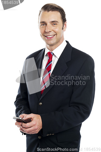 Image of Team leader sending text message to his colleagues