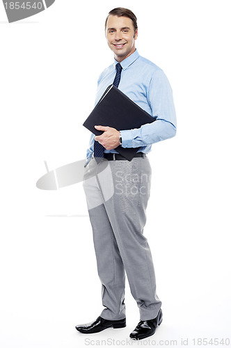 Image of Handsome confident businessperson holding file folder