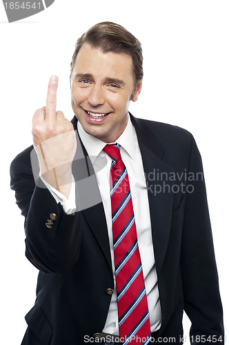 Image of Displeased businessman showing middle finger politely