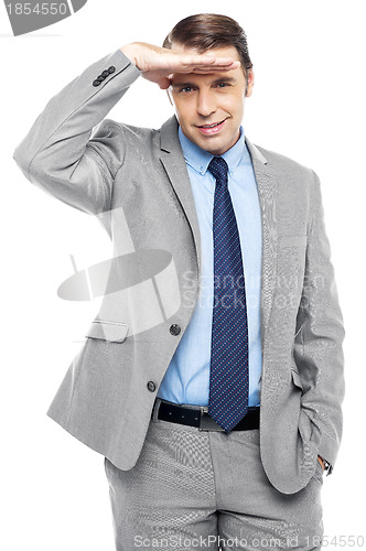 Image of Handsome businessman watching something closely