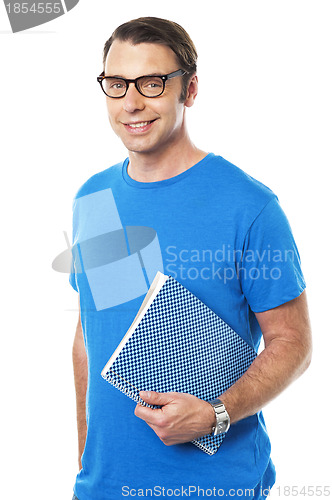 Image of Casual young guy holding notepad