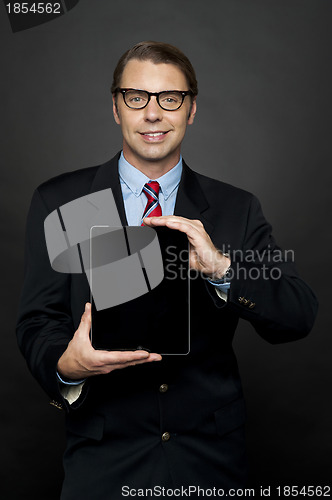 Image of Portrait of businessman showing new digital device
