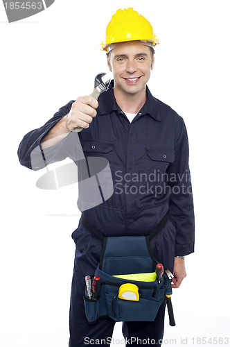 Image of Smiling repairman holding out screwdriver