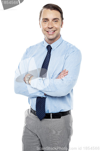 Image of Smiling young team leader keeping his arms folded