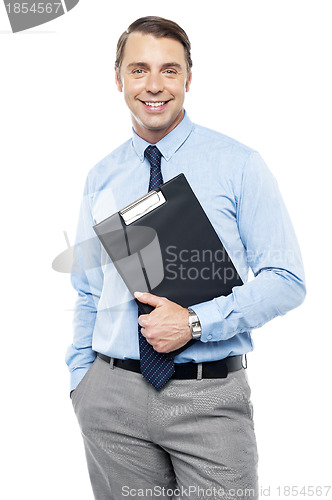 Image of Handsome smiling executive holding clipboard